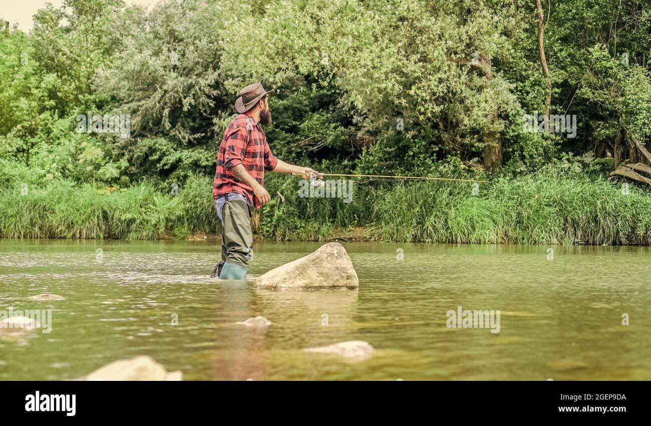 The Addiction is Real. sport activity hobby. experienced fisher in water.  Successful fly fishing. summer weekend. man catching fish. mature man fly  Stock Photo - Alamy