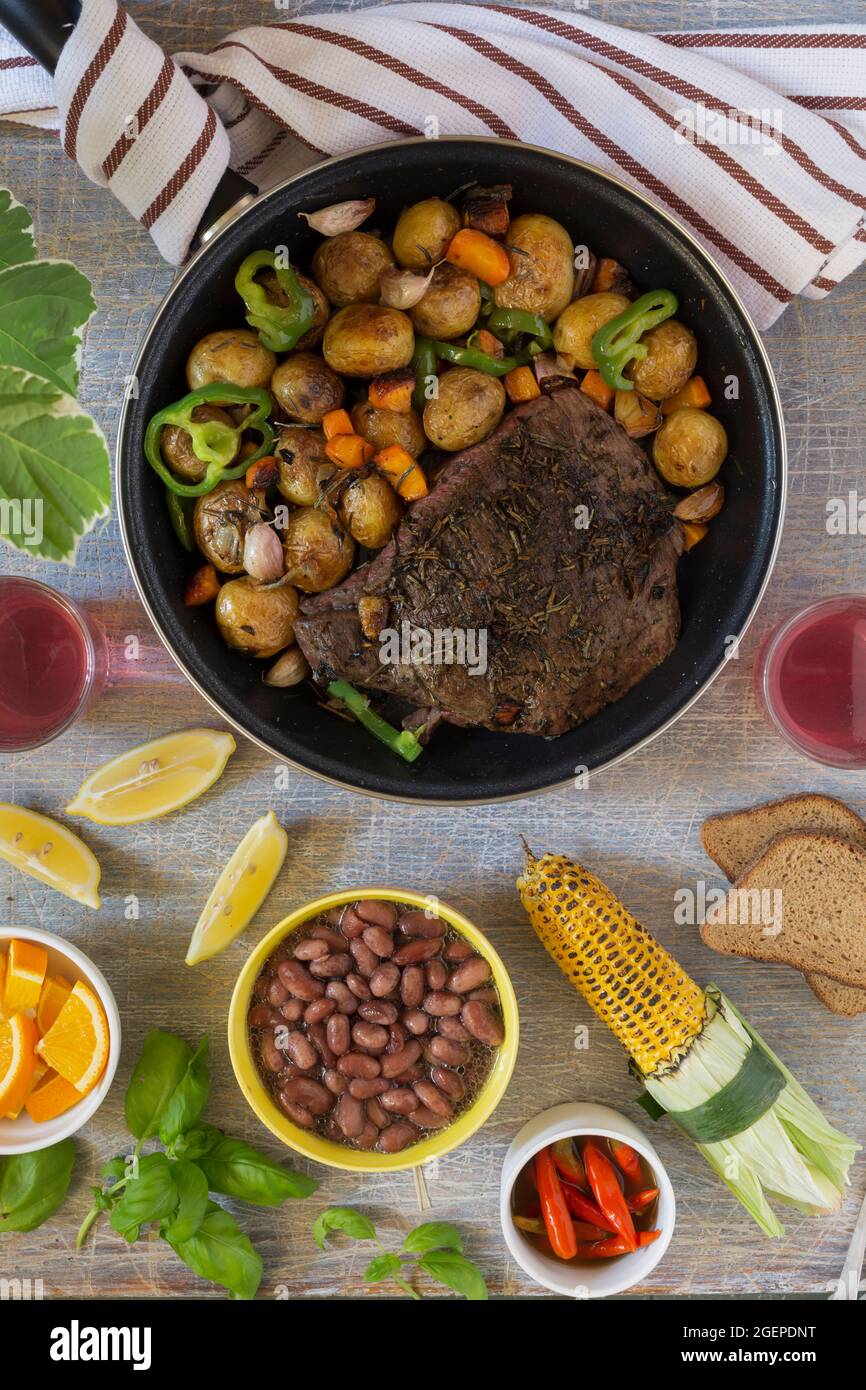 Traditional lunch American cooking grilled steak and various vegetables ...