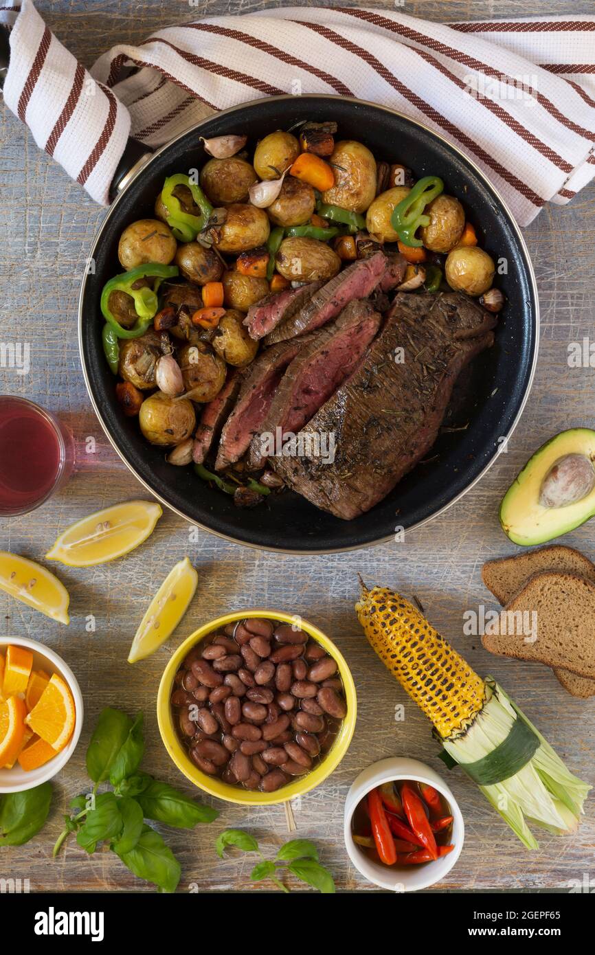 Traditional lunch American cooking grilled steak and various vegetables ...