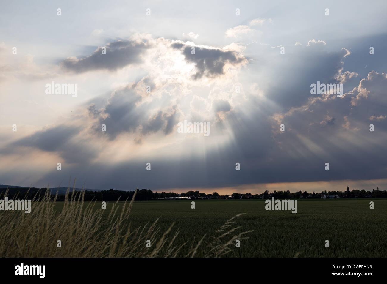 Rays of sunlight break through the clouds Stock Photo