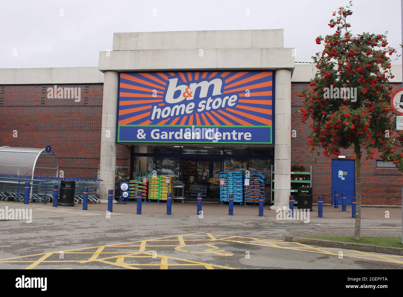 B&M store front, home store and garden centre with blue sky and copy space. Wigan, UK Stock Photo