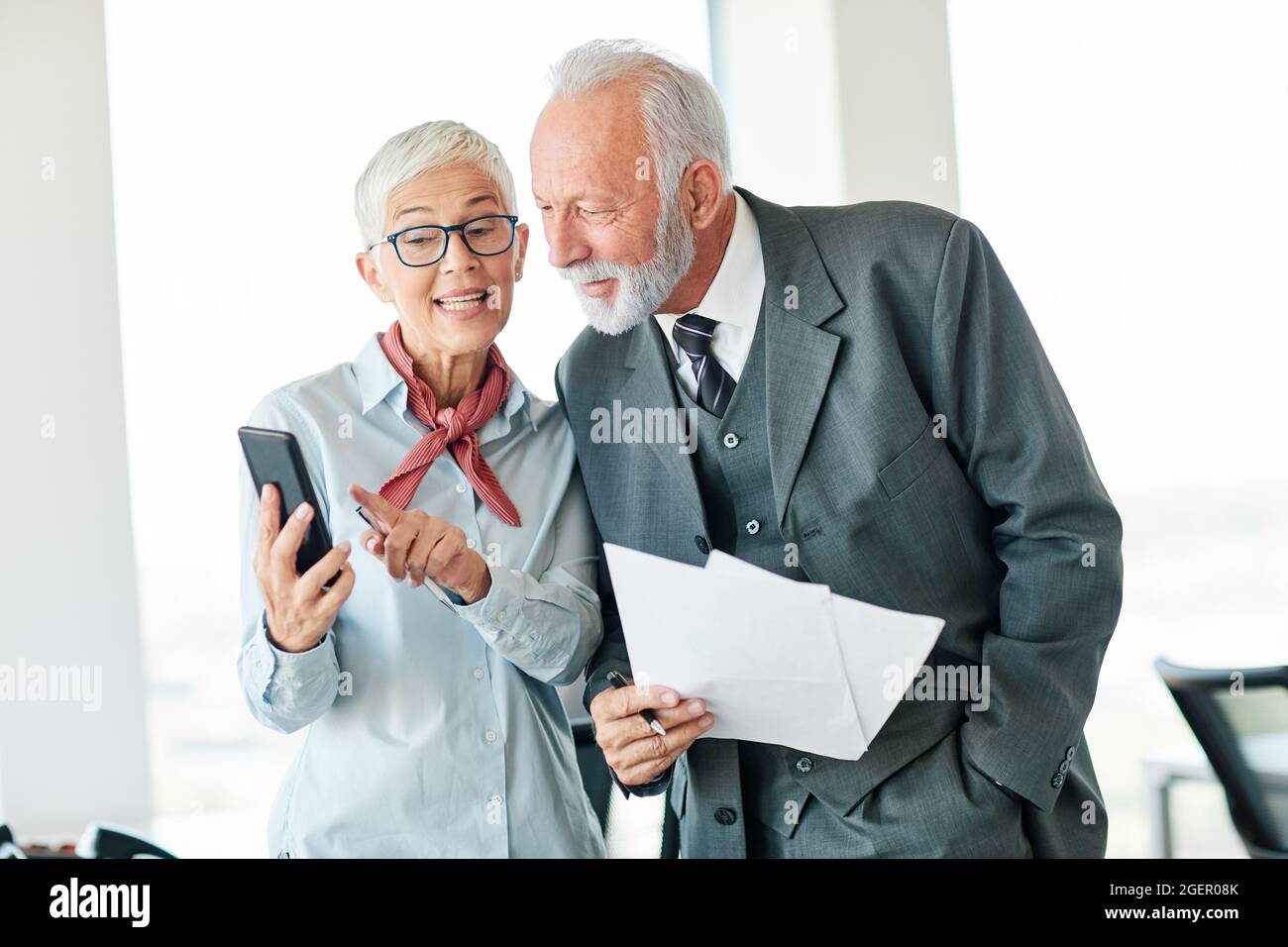 business office person discussion mobile phone teamwork senior meeting Stock Photo