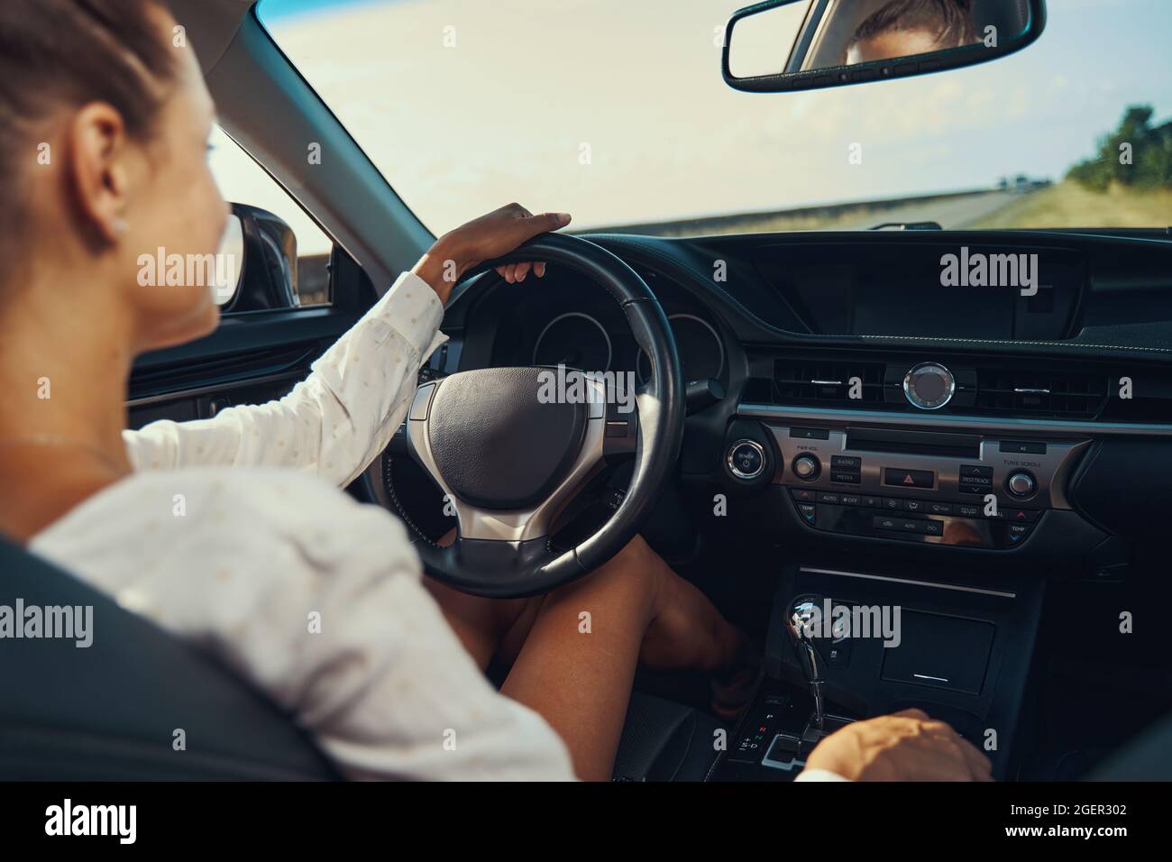 Woman sitting behind steering wheel hi-res stock photography and images ...