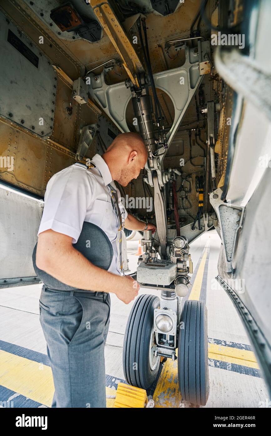 Airline captain examining the landing gear system Stock Photo Alamy