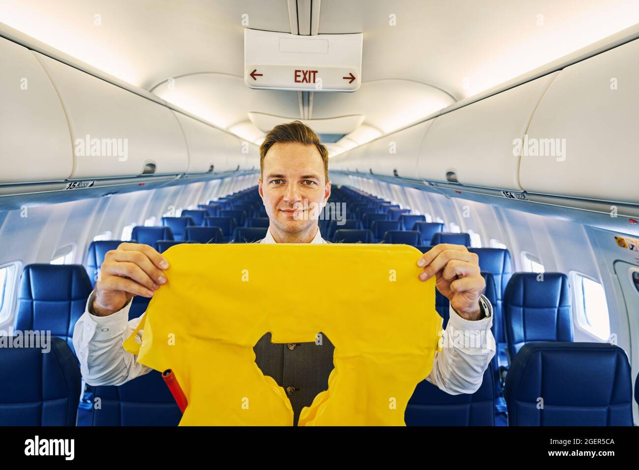 Flight attendant showing a lifejacket during the preflight safety demonstration Stock Photo Alamy