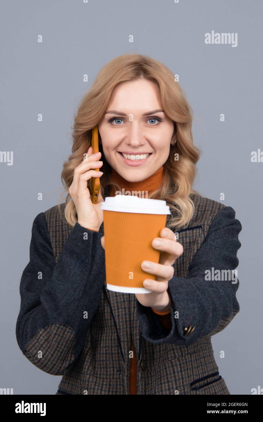 Good morning. Happy woman give cup talking on phone. Enjoying her morning coffee Stock Photo