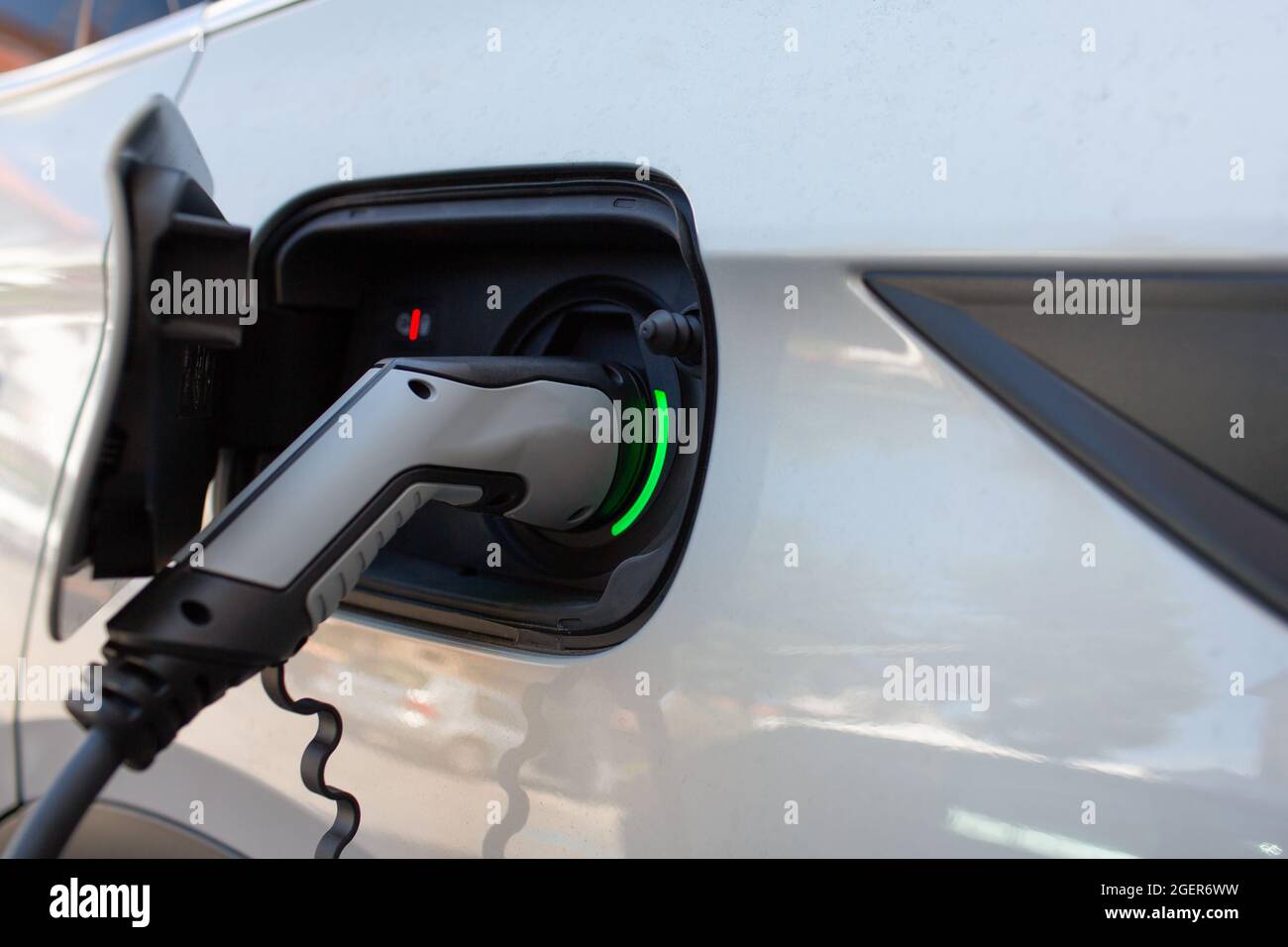 detail of the power outlet of an electric car recharging batteries in a