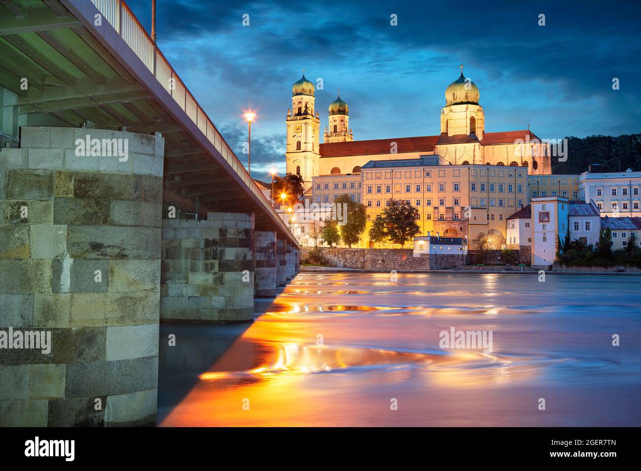 Passau, Germany. Cityscape image of Passau with the St. Stephan's Cathedral and Mary's Bridge or Mariensbrucke over Inn River at twilight blue hour. Stock Photo