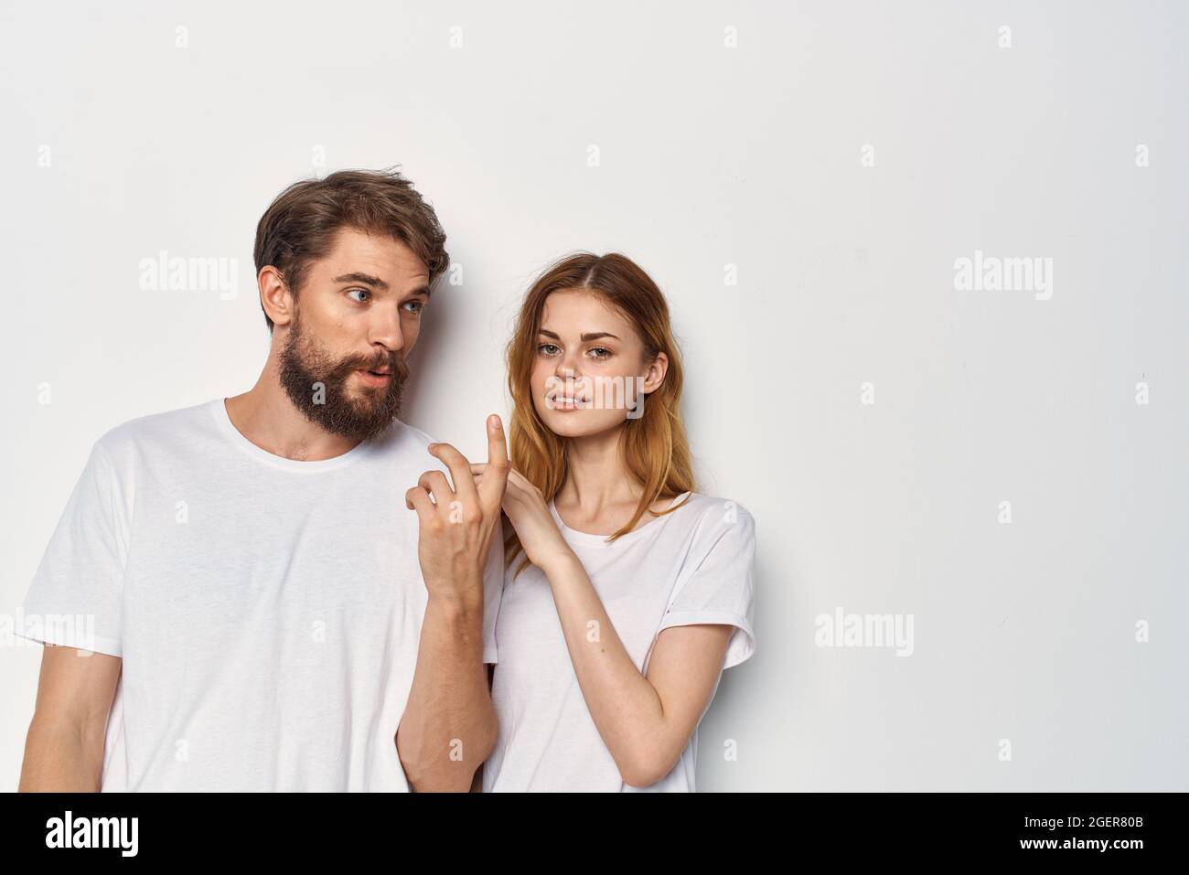 funny man and woman in white tshirts are standing side by side
