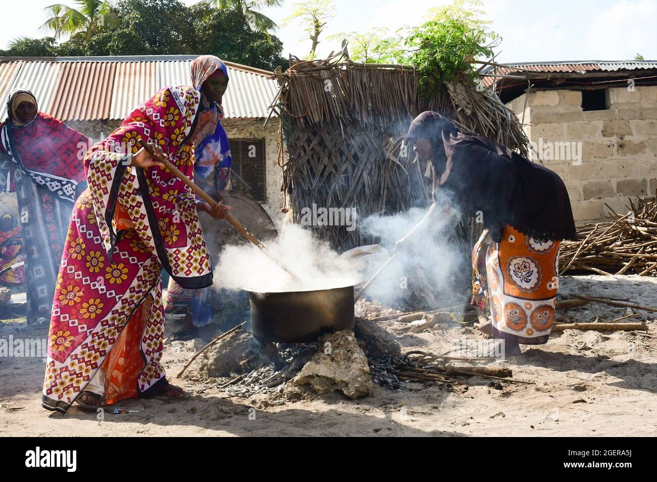 Matemwe, Tanzania. 30th July, 2021. Women cooking rice in a kettle over