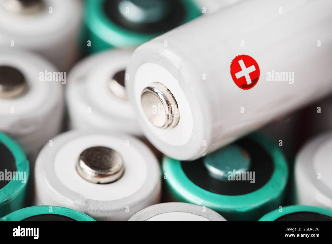 AA rechargeable batteries with a white battery with a positive polarity. Selective focus Stock Photo