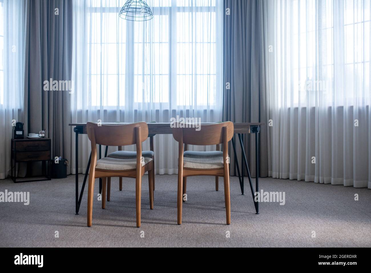 Table with chairs in center of room Stock Photo Alamy