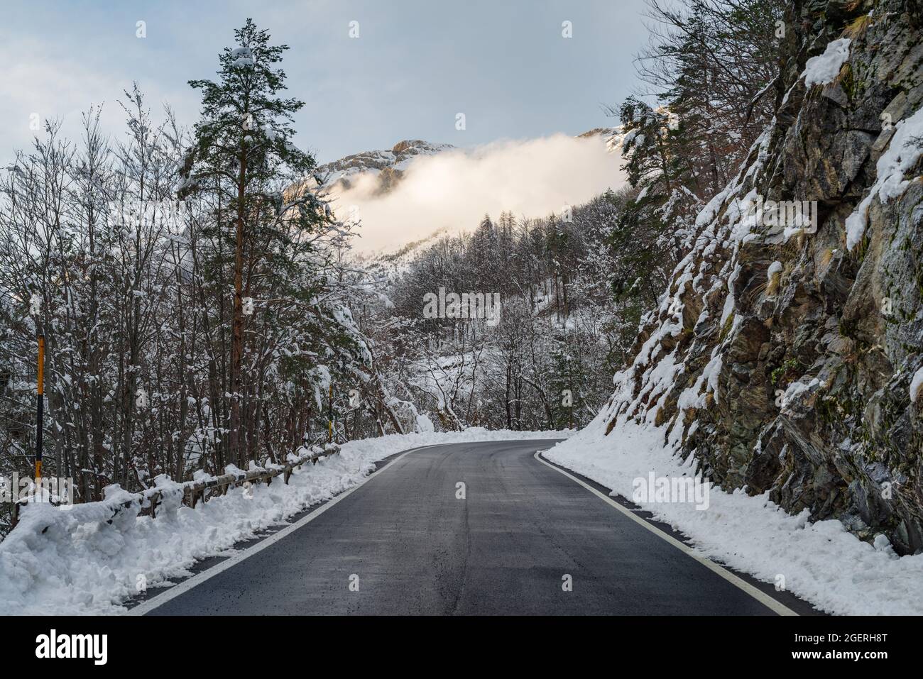 Empty road through snow mountains hi-res stock photography and images ...