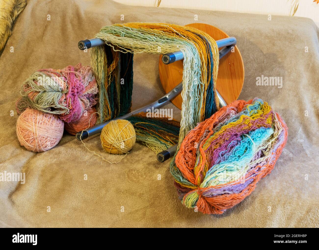 picture with yarn spools and balls of wool thread, skeins prepared for ...