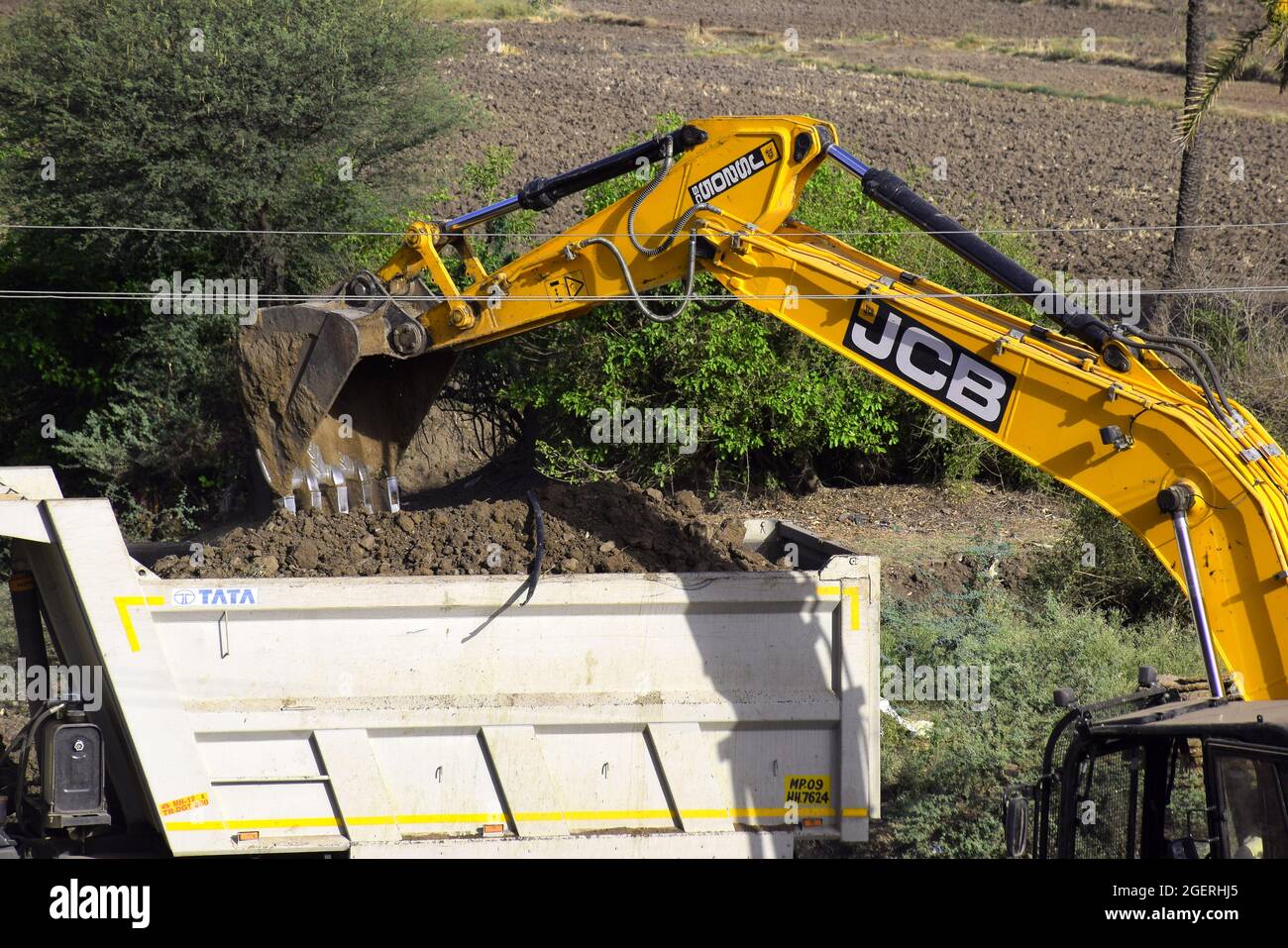 08-05-2020,Bhadapipalya, Madhya Pradesh, India. The modern excavator JCB performs excavation work on the construction site Stock Photo