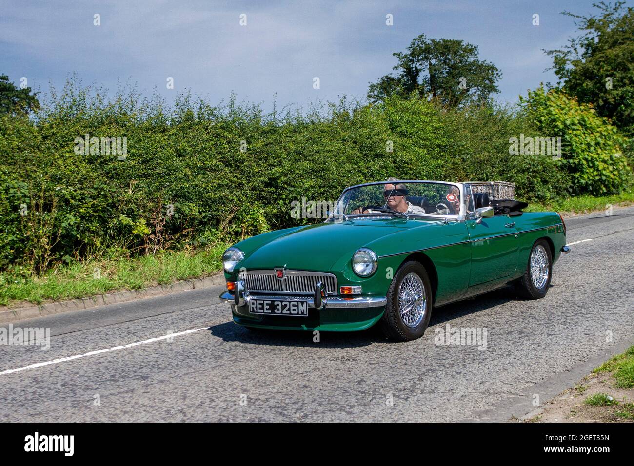 1974 70s green MG B MGB 1798cc petrol 2dr cabrio en-route to Capesthorne Hall classic July car show, Cheshire, UK Stock Photo