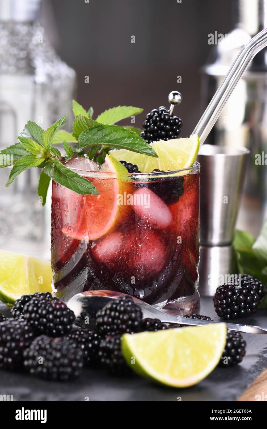 Blackberry summer mojito cocktail. Cold refreshing organic alcoholic drink with berries, lime, mint Stock Photo