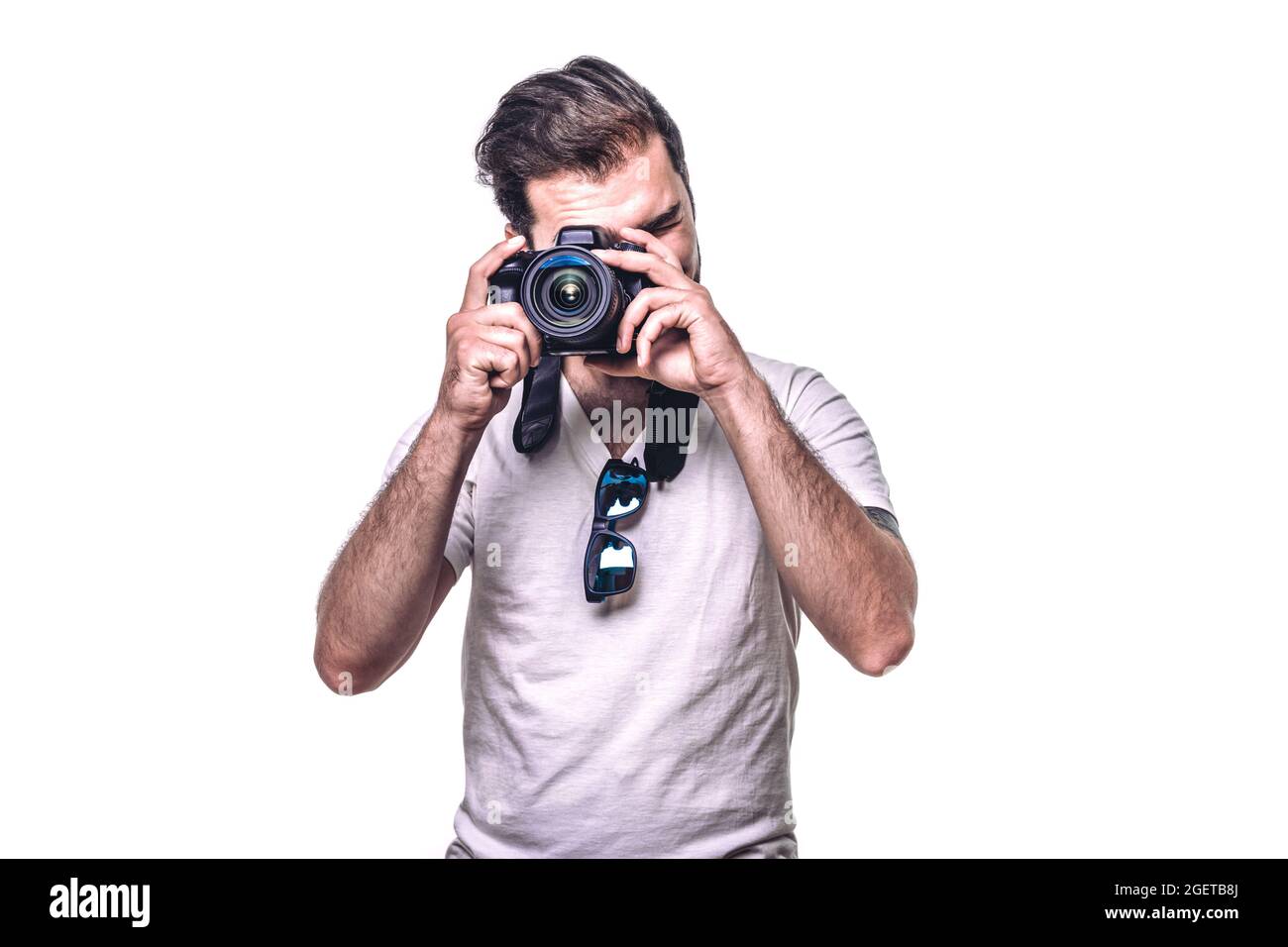 Man holding camera. Boy takes photo in studio. Professional
