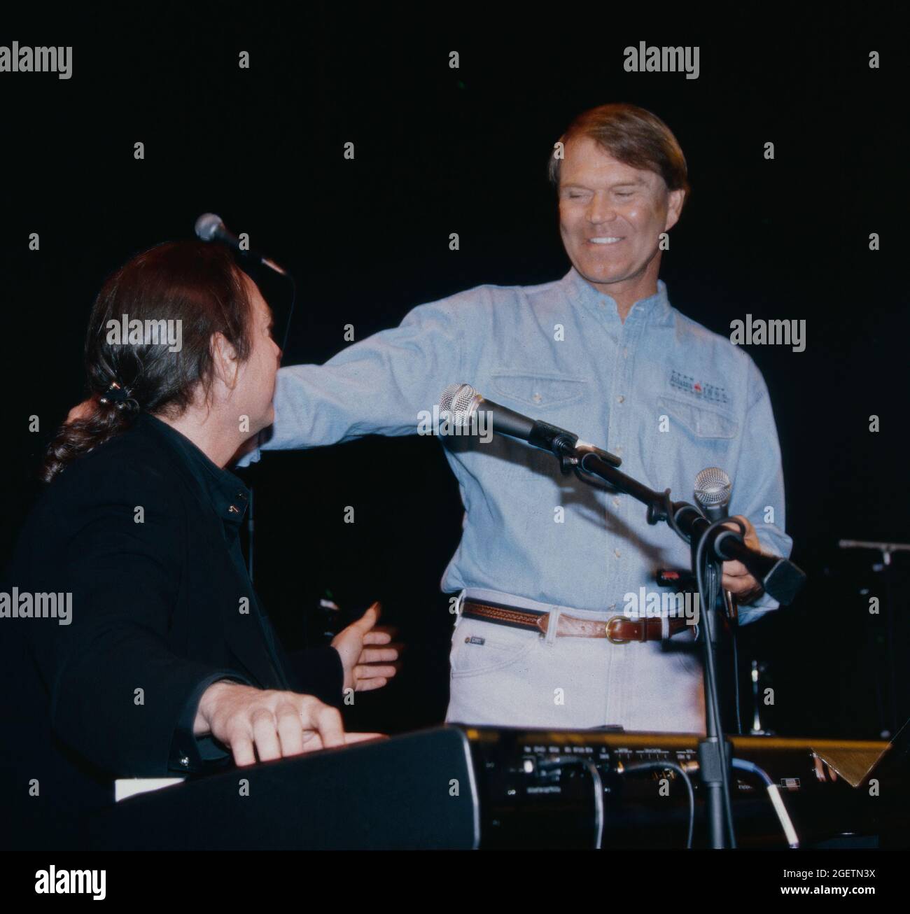 Glen Campbell and song writer, Jimmy Webb give an impromptu performance at Campbell's surprise 60th birthday celebration in Branson, Missouri on April 20, 1996, two days before his actual birthday. Jimmy Webb wrote and collaborated with Campbell on many of his hits including, “By the Time I Get to Phoenix”, “Wichita Lineman” and “Galveston”. Stock Photo