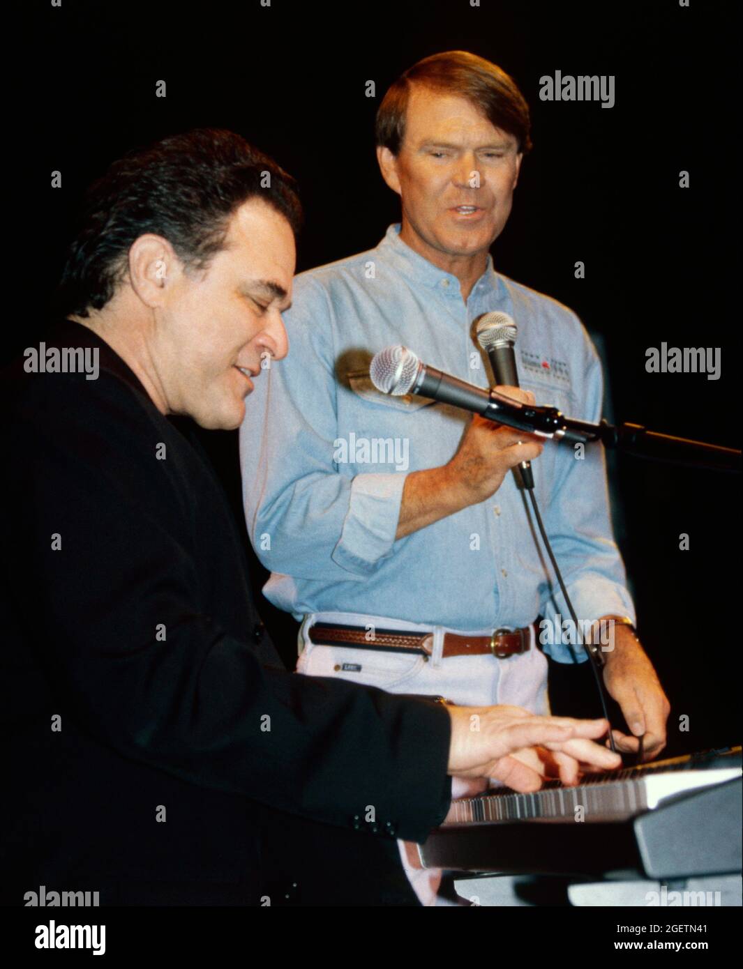 Glen Campbell and song writer, Larry Weiss on keyboard give an impromptu performance of “Rhinestone Cowboy” at Campbell's surprise 60th birthday celebration in Branson, Missouri on April 20, 1996, two days before his actual birthday. Stock Photo