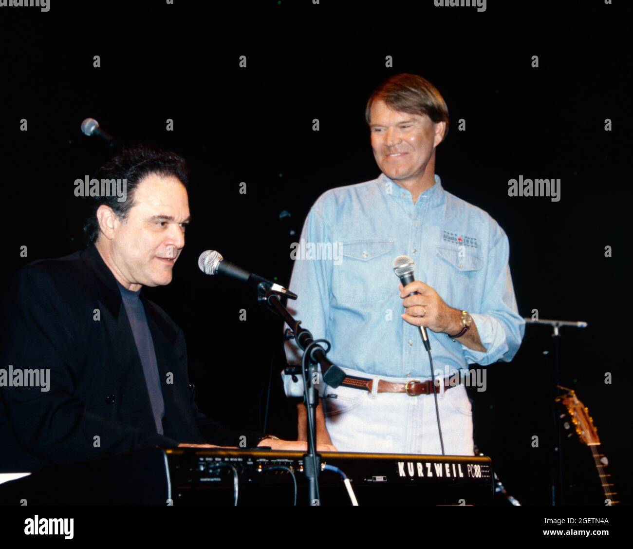 Glen Campbell and song writer, Larry Weiss on keyboard give an impromptu performance of “Rhinestone Cowboy” at Campbell's surprise 60th birthday celebration in Branson, Missouri on April 20, 1996, two days before his actual birthday. Stock Photo
