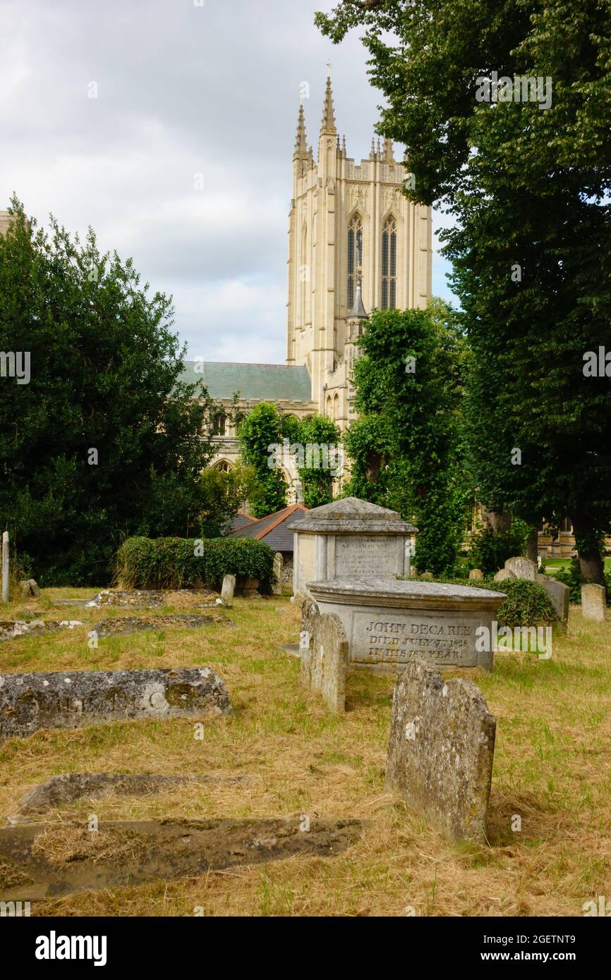 St Edmundsbury Cathedral from St Mary's church graveyard with graves. Bury St edmunds, Suffolk, England Stock Photo