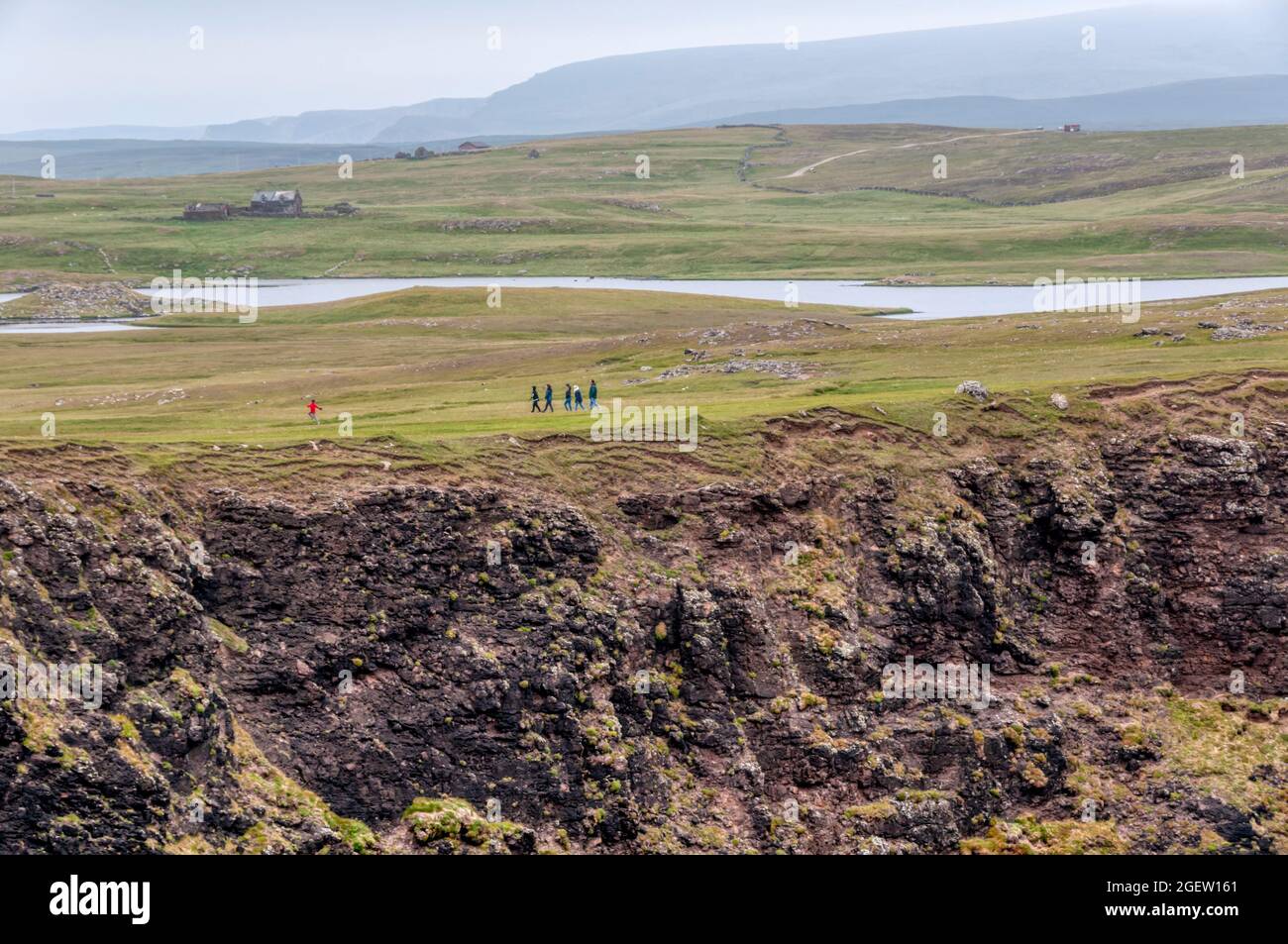 Walkers at Eshaness or Esha Ness in Northmavine on Mainland Shetland. Stock Photo