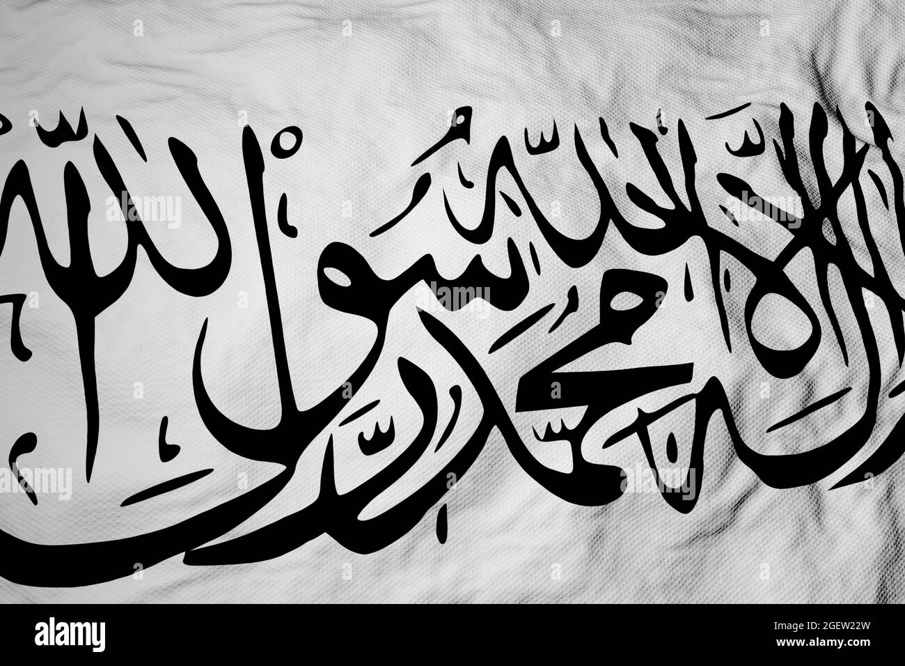 Full frame close-up on a waving Taliban flag (new rulers of Afghanistan). Stock Photo