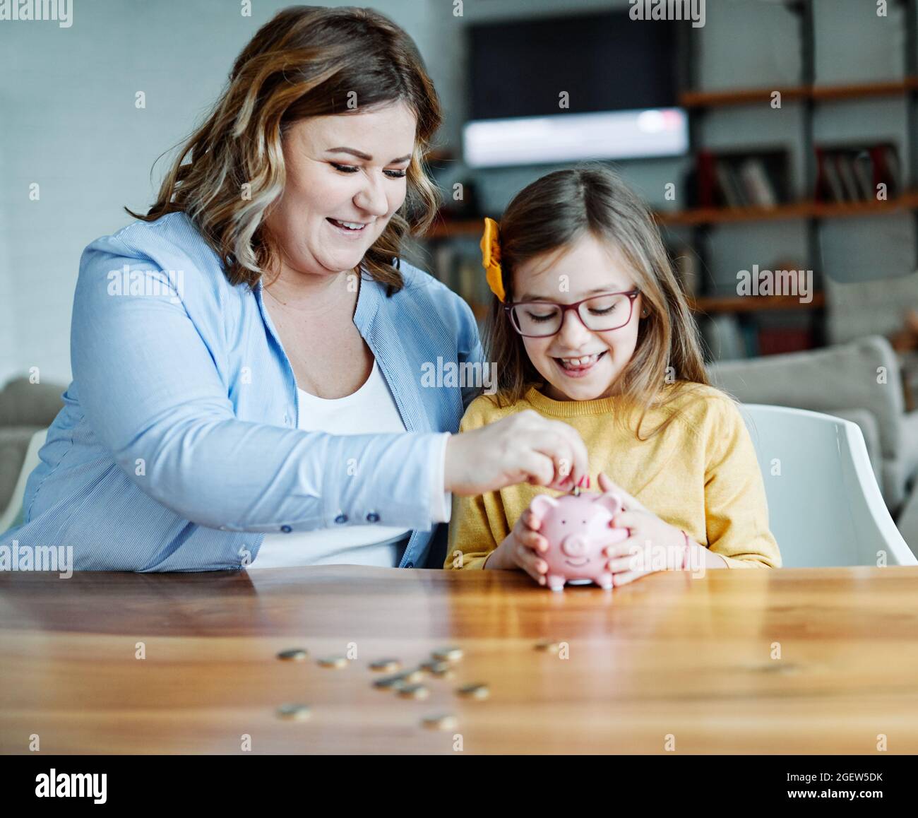 piggy bank mother daughter money savings coin finance Stock Photo - Alamy
