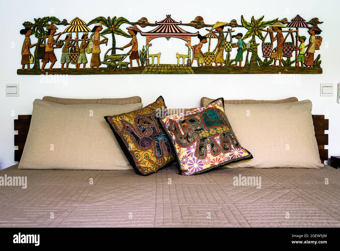 Tangalle, Sri Lanka - Oct 31, 2017: Inside hotel or residential house, bed with pillows and cushions in ethnic style. Bedroom home interior in Indian Stock Photo