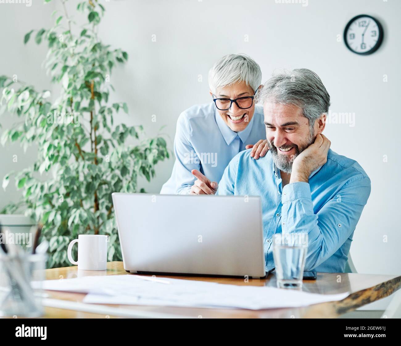 business office person discussion laptop teamwork senior meeting Stock Photo
