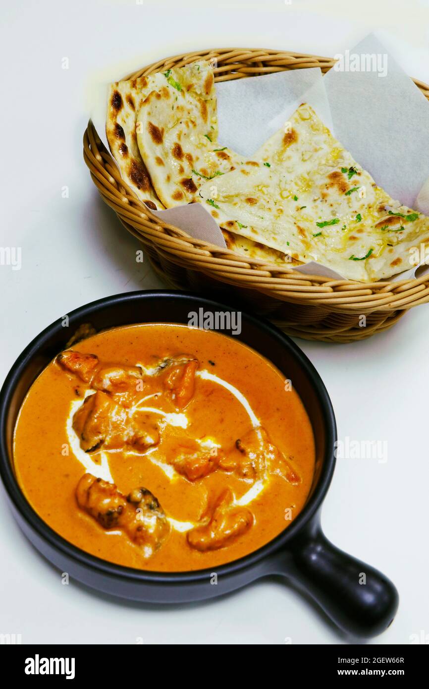 butter chicken curry or masala with garlic naan, indian food delicacy