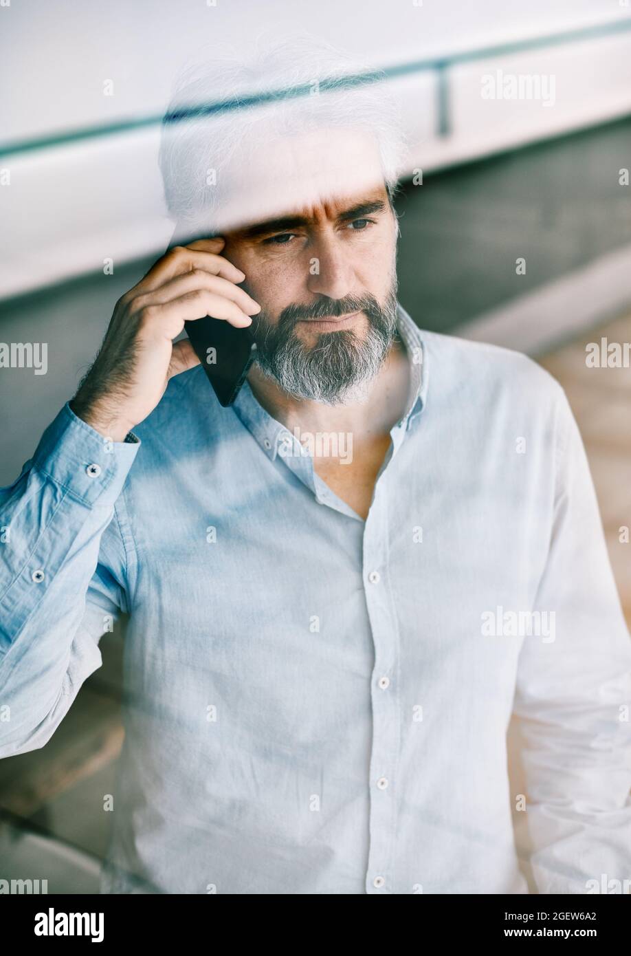 senior businessman man portrait casual smartphone office work business phone Stock Photo