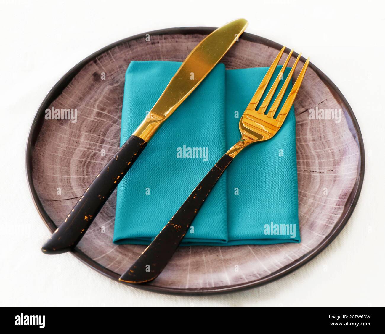 isolated dining cutlery and crockery set, knife and fork on a serving