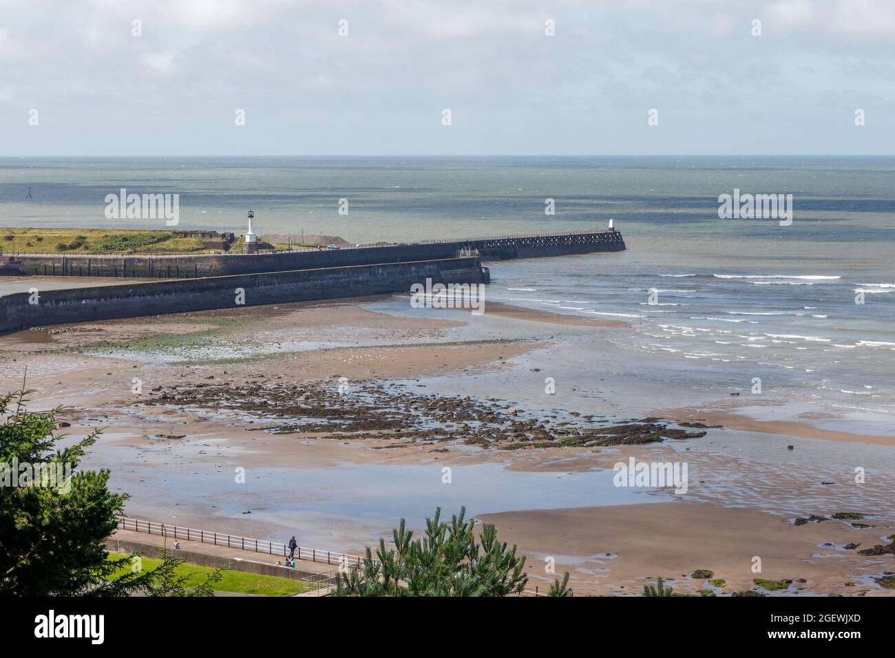 Maryport Harbour and lighthouse viewed from the cliffs near Senhouse Roman Museum Stock Photo