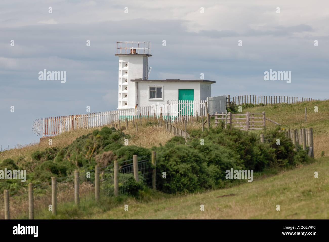 The former foghorn station on the cliff edge at St Bees Head once provided an audible warning to passing ships Stock Photo