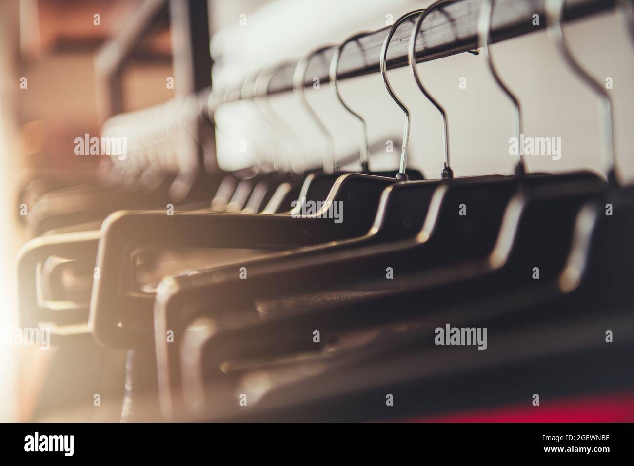 Luxury Clothes Store Showroom. Line of Clothe Hangers Hanging on a Rail
