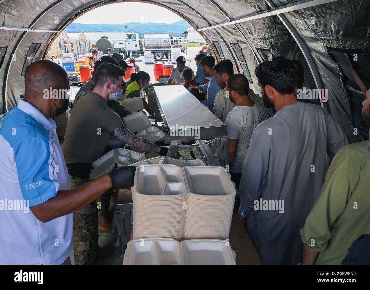 Ramstein Miesenbach, Germany. 21st Aug, 2021. U.S. Air Force airmen prepare  meals for Afghan refugees evacuated from Kabul after arrival at Ramstein  Air Base August 21, 2021 in Ramstein-Miesenbach, Germany. Ramstein Air