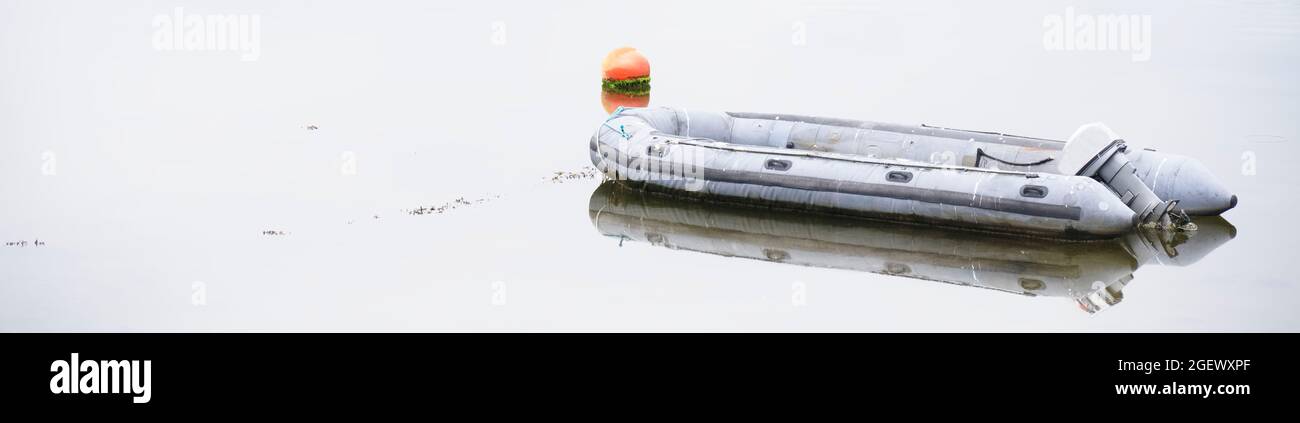 Inflatable dingy life rescue boat moored at marina Stock Photo - Alamy