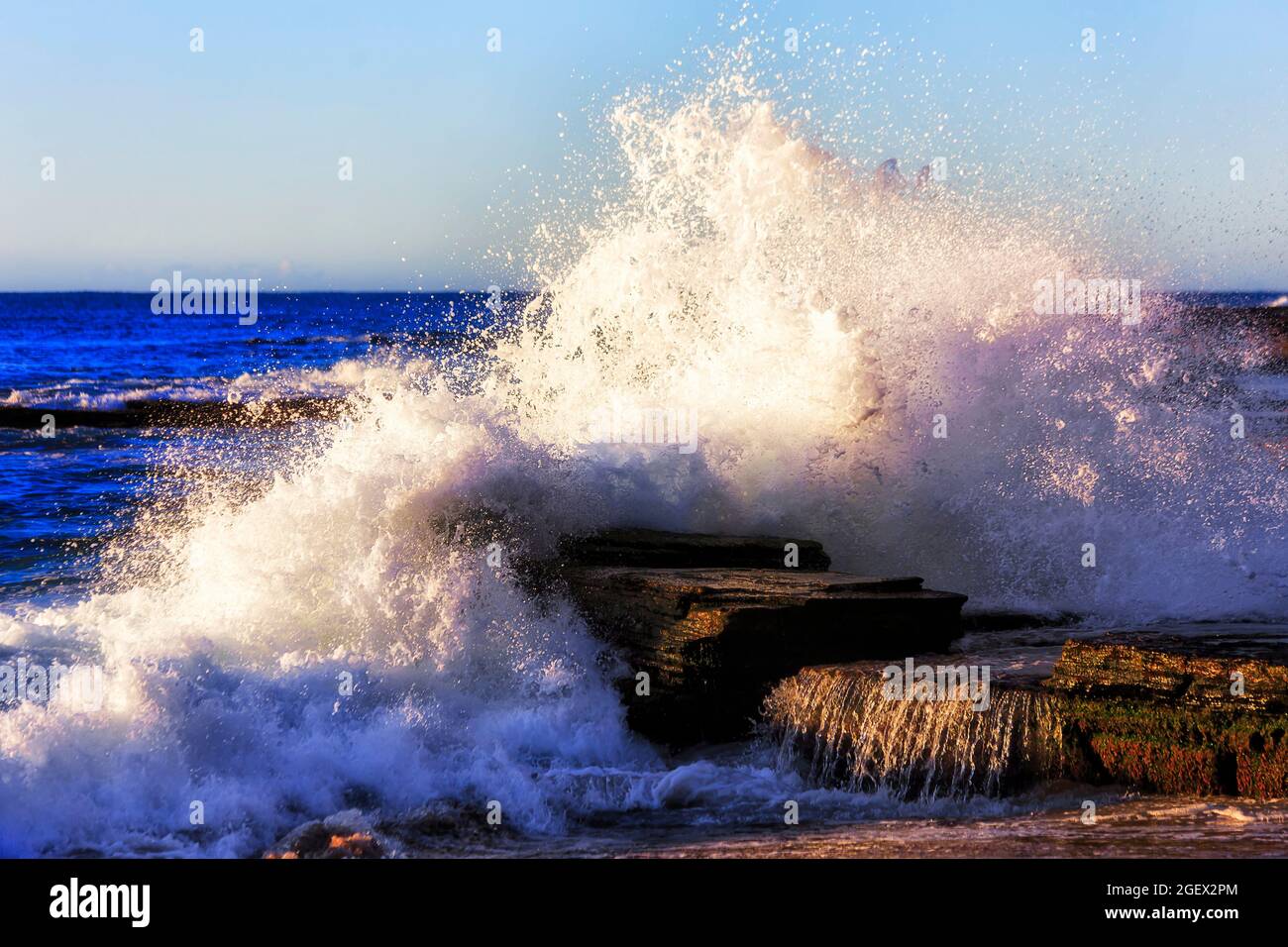 Huge wave hitting rocks at Turimetta beach of Sydney Northern beaches