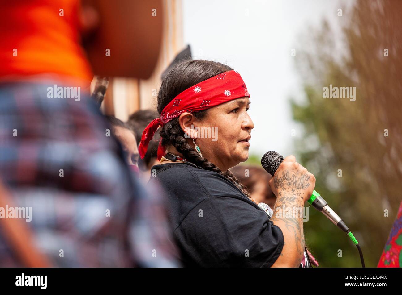 Washington, DC, USA, 21 August, 2021.  Pictured: A protester speaks about the harmful consequences of fossil fuels at a Native American ceremonial gathering at the National Museum of the American Indian (a Smithsonian musuem) to protest Enbridge's Line 3 tar sands oil pipeline.  The pipeline passes through treaty lands and the headwaters of the Mississippi River, to carry tar sands oil from Canada. Stock Photo