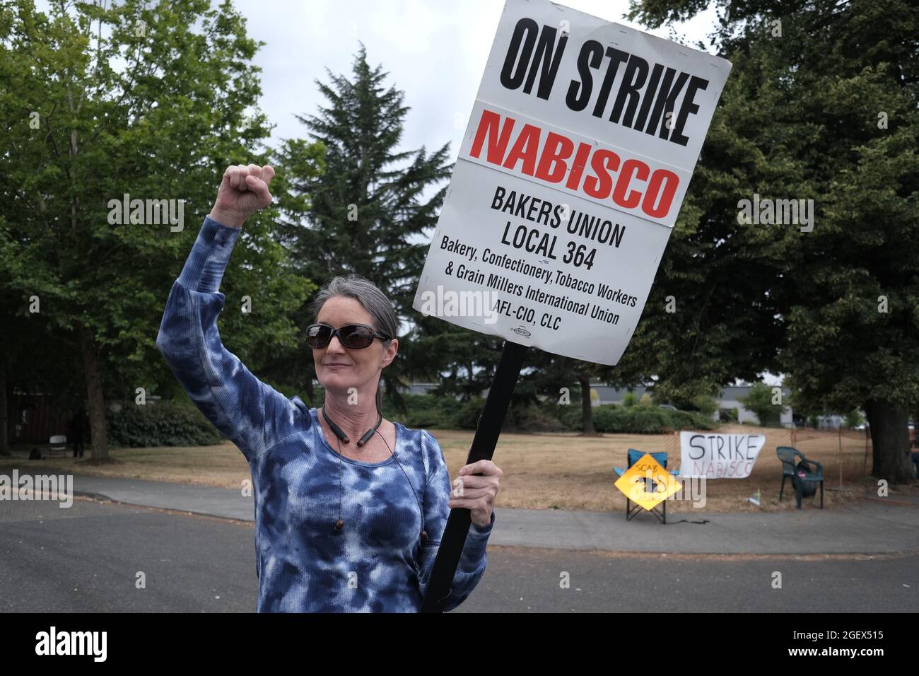 Nabsico worker Sarah Davis, 54, with the Bakery, Confectionery, Tobacco  Workers and Grain Millers International Union Local 364 strike outside  their bakery owned by Mondelez International in Portland, Ore., on August  21,