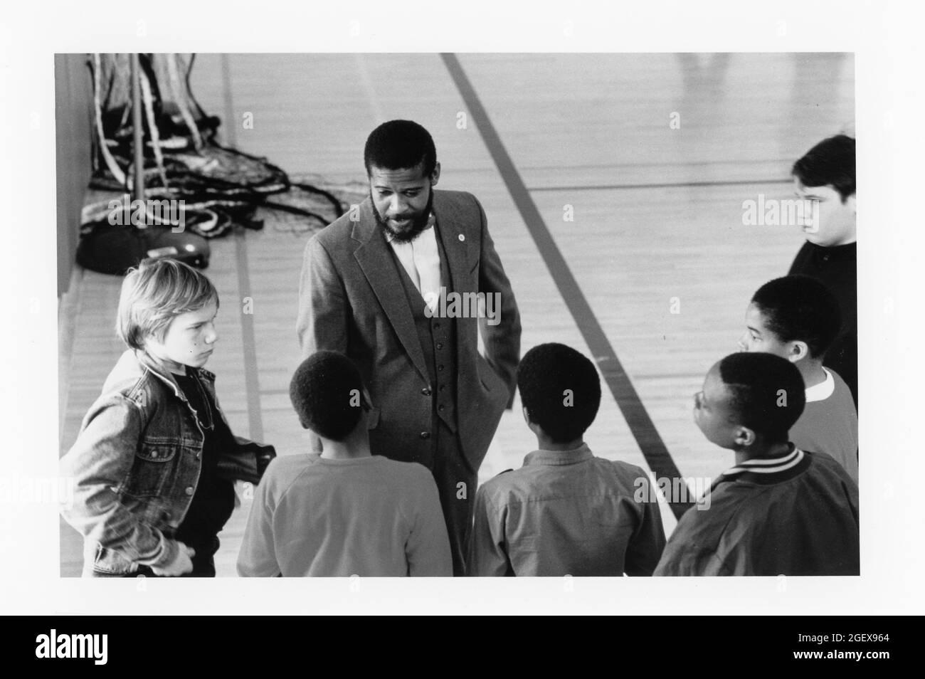 Austin Texas USA, circa 1992: Black businessman and community leader giving career counseling to teen boys at middle school career day.  ©Bob Daemmrich Stock Photo