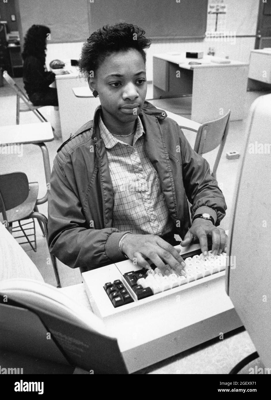 Austin Texas USA, circa 1991: Black college student works on programming in community college classroom. ©Bob Daemmrich Stock Photo