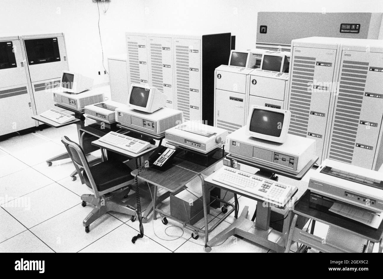 Austin Texas USA, 1990: Desktop computer terminals, printers, and a bank of mainframe computers are ready for data entry at a United States Census data processing facility during the decennial count of people living in the country. ©Bob Daemmrich Stock Photo