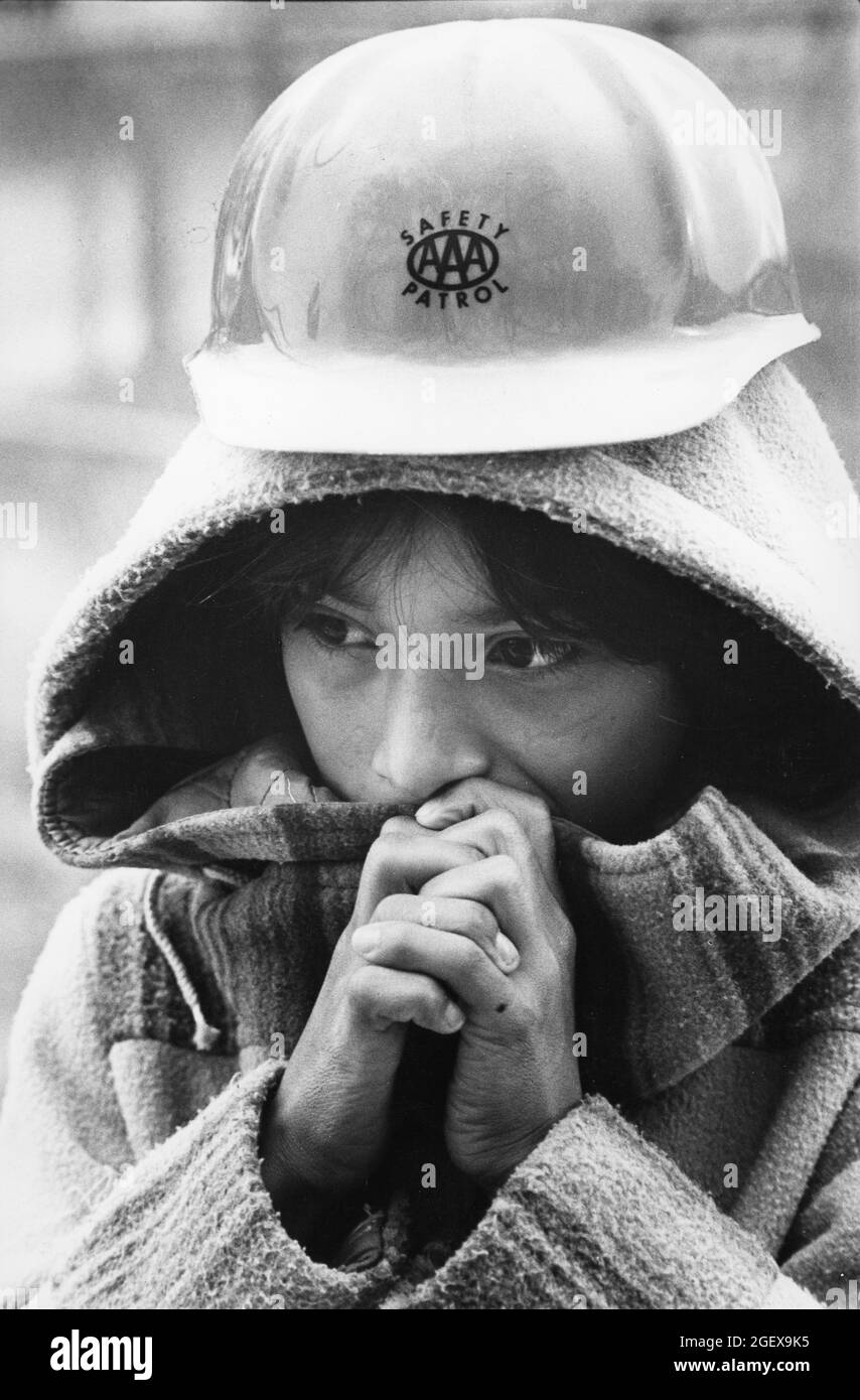 Austin Texas USA, circa 1993: Fifth grade girl trues to stay warm while serving on safety patrol duty outside Walnut Creek Elementary on a cold morning.  ©Bob Daemmrich Stock Photo