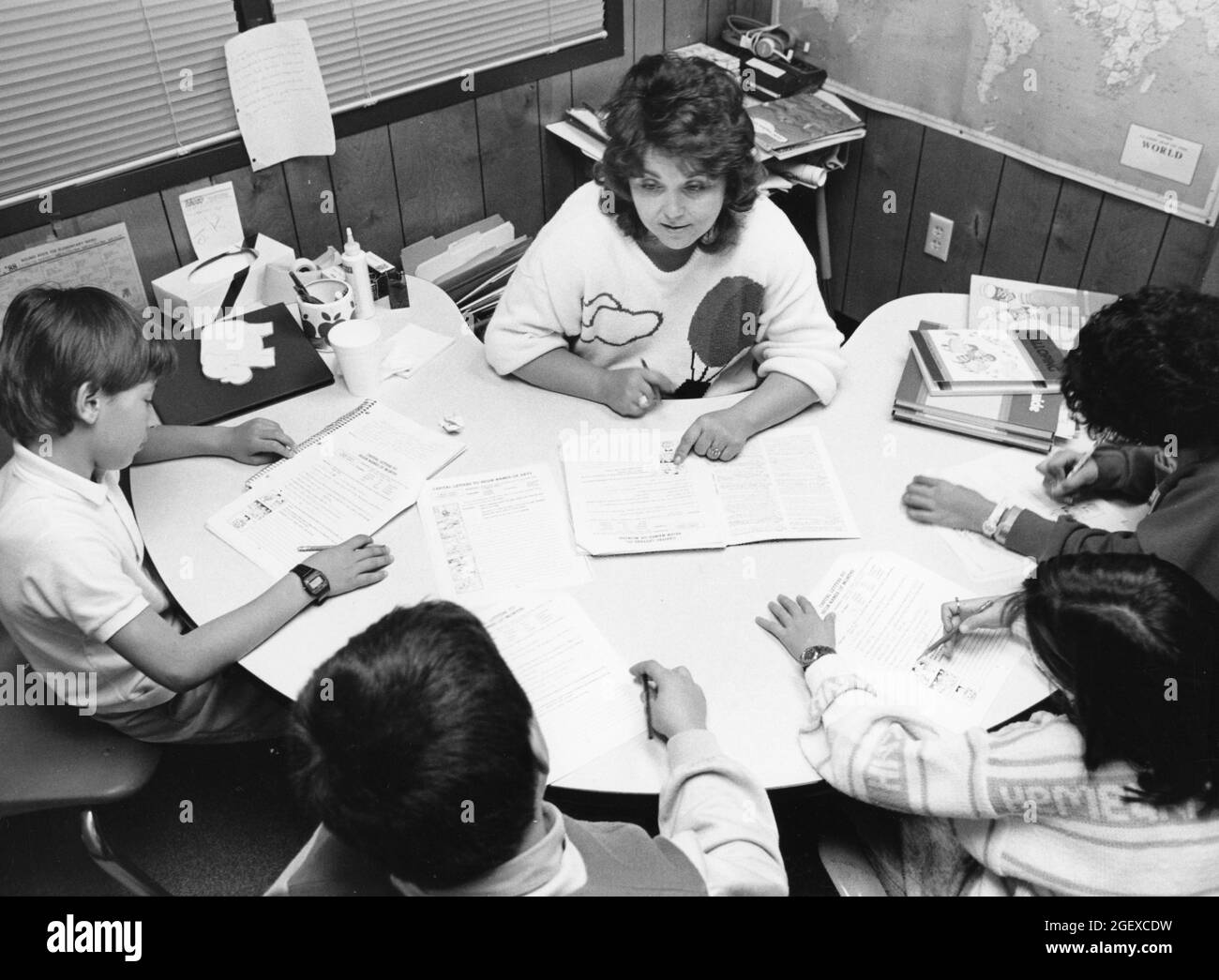 Austin Texas USA, circa 1991: Female public elementary school teacher working with English as a Second Language(ESL) students in her classroom. ©Bob Daemmrich Stock Photo