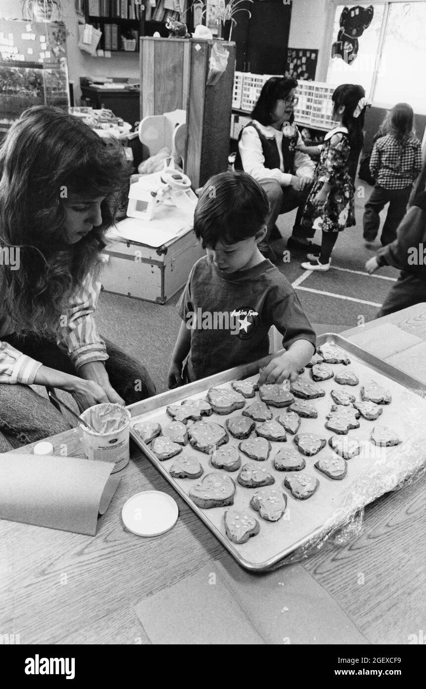 Austin Texas USA,1994: Pre-kindergarten children making Valentine's Day cookies in class at Lake Travis Elementary School. MR EI-0047 ©Bob Daemmrich Stock Photo