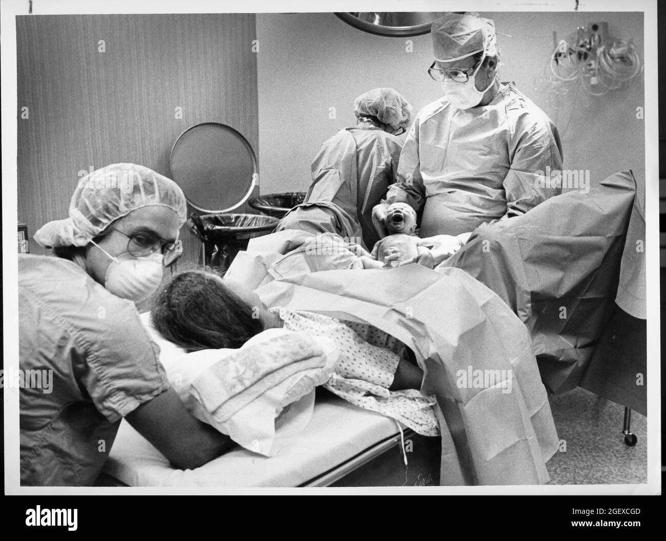Austin Texas USA, 1982: Childbirth story that ran in the Austin American-Statesman in 1982..Obstetrician attends birth of woman's child in hospital labor-delivery room with labor-delivery nurses assisting. File 82-48 Box #12  birth was 6-2-1982. Stock Photo