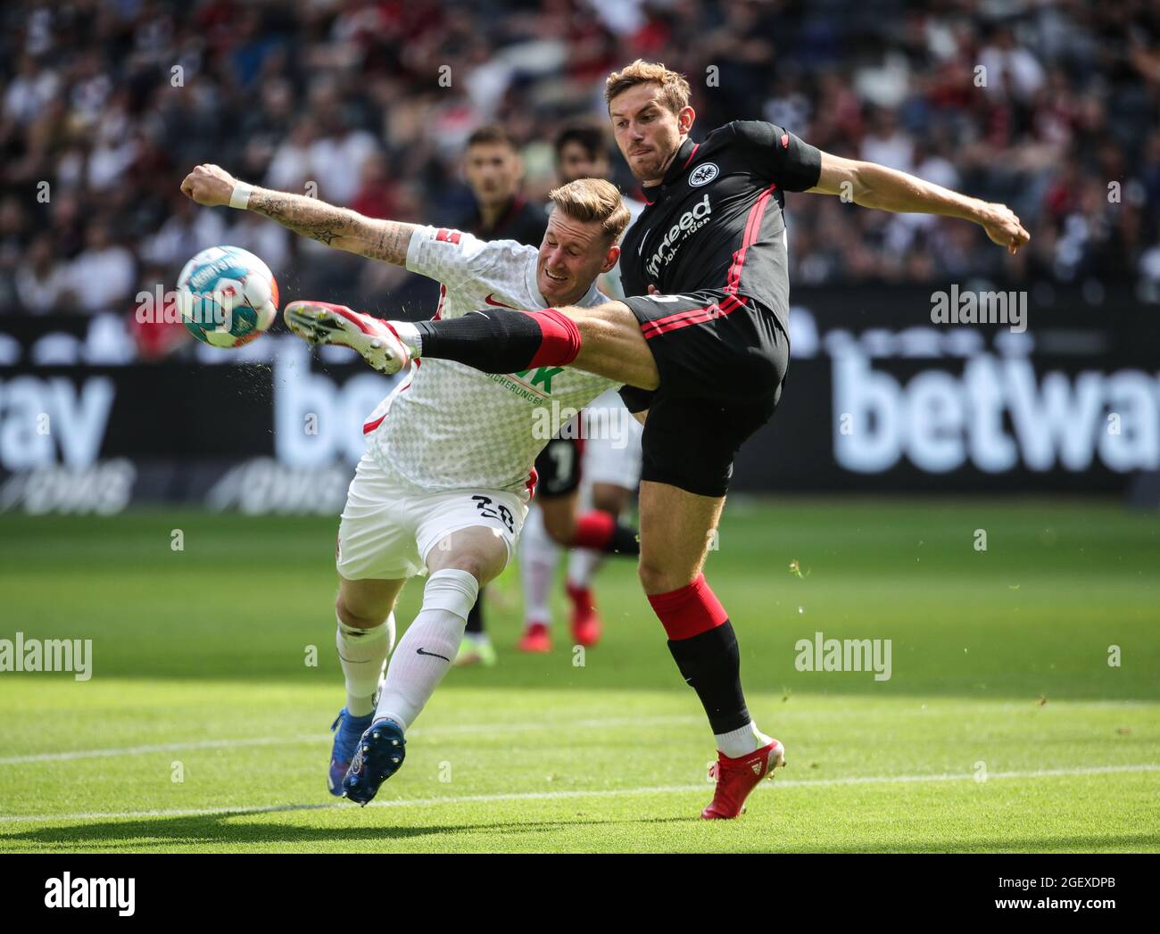 Frankfurt, Germany. 21st Aug, 2021. Christopher Lenz (R) of Frankfurt vies with Andre Hahn of Augsburg during the German first division Bundesliga football match between Eintracht Frankfurt and FC Augsburg in Frankfurt, Germany, Aug. 21, 2021. Credit: Armando Babani/Xinhua/Alamy Live News Stock Photo